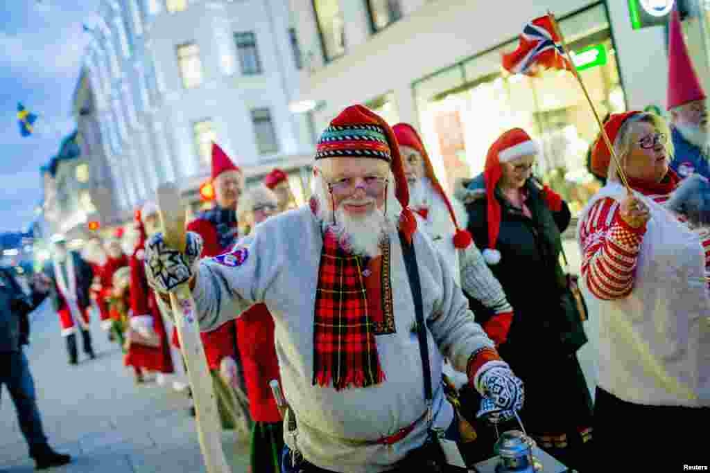 A procession of people dressed as Santa Claus walk down the main street of Oslo, Norway. The people were headed to the Norwegian Parliament building to promote the upcoming &quot;Santa&rsquo;s Winter Games&quot;.