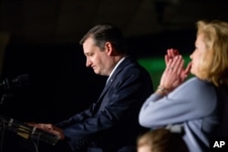 Republican presidential candidate Sen. Ted Cruz, accompanied by his wife, Heidi, right, pauses while speaking at his South Carolina primary night rally at the South Carolina State Fairgrounds in Columbia, Feb. 20, 2016.