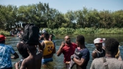 Migrants wade back and forth across the Rio Grande from Ciudad Acuña, Mexico, into Del Rio, Texas, Sept. 19, 2021.