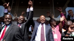 Kenya's presidential candidate Uhuru Kenyatta (C) and his running mate William Ruto (2nd L) celebrate winning the presidential election with supporters after the official result was released in Nairobi, March 9, 2013. 