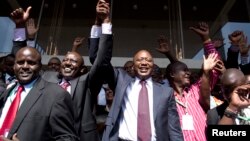 Kenya's presidential candidate Uhuru Kenyatta (C) and his running mate William Ruto (2nd L) celebrate winning the presidential election with supporters after the official result was released in Nairobi, March 9, 2013. 