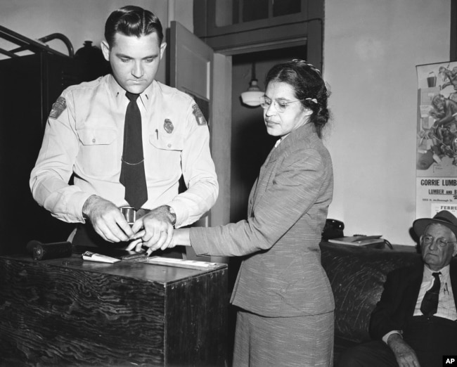 FILE - Rosa Parks, whose refusal to move to the back of a bus, touched off the Montgomery bus boycott and the beginning of the civil rights movement, is fingerprinted by police Lt. D.H. Lackey in Montgomery, Alabama, Feb. 22, 1956.