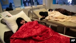 FILE - Women are treated for a suspected cholera infection at a hospital in Sanaa, Yemen, May 15, 2017.