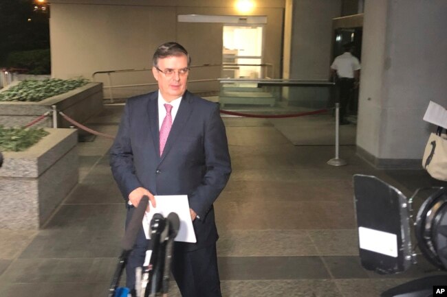 Mexican Foreign Minister Marcelo Ebrard gets ready to talk to reporters as he leaves the State Department in Washington, June 7, 2019.