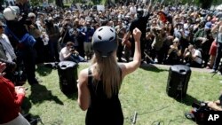 In this April 27, 2017 photo, Lauren Southern wears a protective helmet as she speaks during a rally for free speech near the University of California, Berkeley campus in Berkeley, California. (AP Photo/Marcio Jose Sanchez)