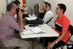 Cuban migrants are registered by Mexican immigration officials in Ciudad Juarez, to be taken across the Paso del Norte International bridge to be processed as asylum-seekers on the U.S. side of the border, April 29, 2019.