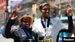 Atsede Baysa and Lemi Berhanu Hayle, both from Ethiopia, pose for a photograph after winning the 120th Boston Marathon, April 18, 2016. Credit: Greg M. Cooper-USA TODAY