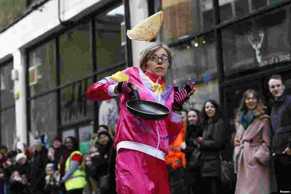 A participant takes part in the annual Great Spitalfields Pancake Race to raise money for London's Air Ambulance.