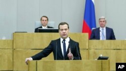 Russian Prime Minister Dmitry Medvedev, foreground, delivers his annual report to lawmakers in the State Duma (lower parliament chamber) in Moscow, Russia, April 21, 2015.