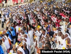The crowd of Ugandans excitedly greets Pope Francis as he makes his way toward them, in Namugongo, Nov. 28, 2015.