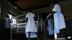 Medical personal prepare isolation unit to care for victims following a new outbreak of Ebola, near Kampala, Uganda, Nov. 15, 2012.