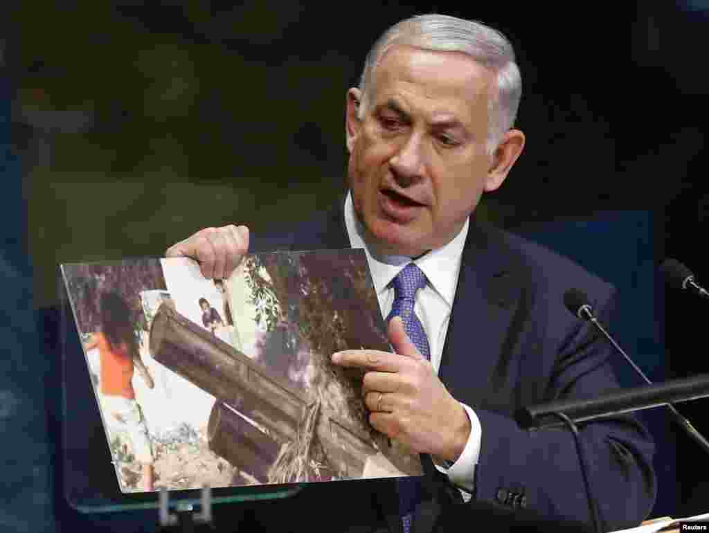 Israel's Prime Minister Benjamin Netanyahu refers to a photograph as he addresses the 69th United Nations General Assembly at the U.N. headquarters in New York, Sept. 29, 2014.