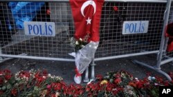 Carnations lay on the ground, near the scene, a day after an attack at a popular nightclub in Istanbul, Monday, Jan. 2, 2017. 