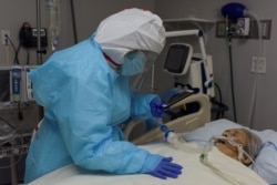 While FaceTiming her siblings, Angelica Mendez, 48, says goodbye to her mother, Catalina Salazar, 86, who is struggling to fight the coronavirus disease (COVID-19), and who died later in the day at United Memorial Medical Center in Houston, Texas, U.S., S