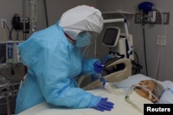 While FaceTiming her siblings, Angelica Mendez, 48, says goodbye to her mother, Catalina Salazar, 86, who is struggling to fight the coronavirus disease (COVID-19), and who died later in the day at United Memorial Medical Center in Houston, Texas, U.S., S