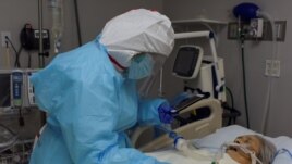 While FaceTiming her siblings, Angelica Mendez, 48, says goodbye to her mother, Catalina Salazar, 86, who is struggling to fight the coronavirus disease (COVID-19), and who died later in the day at United Memorial Medical Center in Houston, Texas, U.S., S