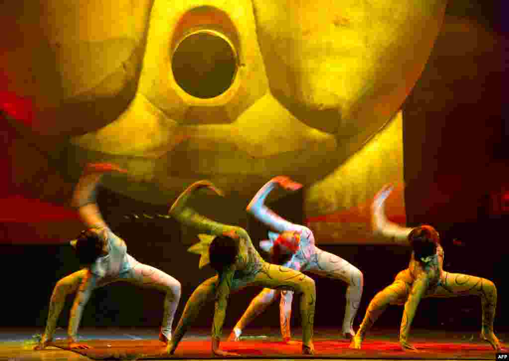 Artists of the Eoloh circus perform during a rehearsal for medias at the Nuevo Teatro Alcala in Madrid, Spain.