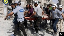Syria Civil Defense "White Helmets" rescue people from site of airstrikes, al-Sakhour neighborhood of eastern Aleppo, Syria, Sept. 21, 2016.