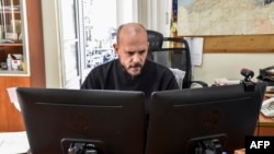 FILE - Aymeric Vincenot, AFP's Algiers bureau chief, sits at his office in the capital Algiers, March 1, 2019.