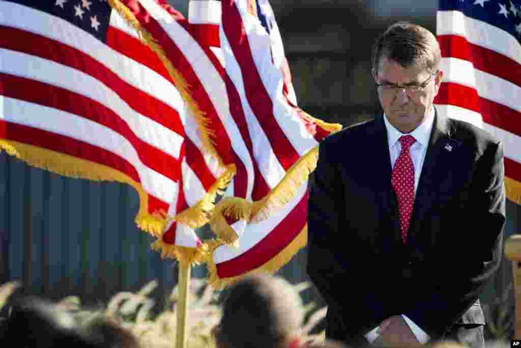 Defense Secretary Ash Carter bows his head during a moment of silence at the Pentagon Memorial, Sept. 11, 2015, during a service on the 14th anniversary of the terrorist attacks.