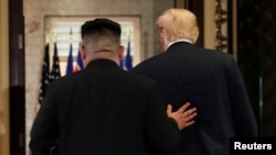 FILE - US President Donald Trump and North Korea's leader Kim Jong Un leave after signing documents that acknowledge the progress of the talks and pledge to keep momentum going.