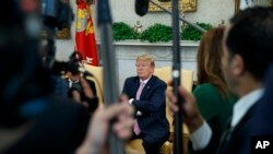 President Donald Trump pauses as he speaks during a meeting with Egyptian President Abdel Fattah el-Sissi in the Oval Office of the White House, April 9, 2019, in Washington. 