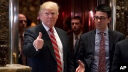 President-elect Donald Trump gives a thumbs up to members of the media after meeting with Martin Luther King III, son of Martin Luther King Jr., at Trump Tower in New York, Jan. 16, 2017.