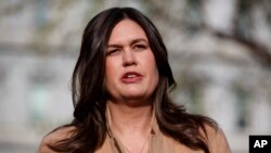 FILE -White House press secretary Sarah Sanders talks with reporters outside the White House in Washington, April 4, 2019.