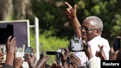 FILE - Uganda's former Prime Minister Amama Mbabazi, now a presidential candidate, speaks to the media at a gathering in Jinja town in eastern Uganda, Sept. 10, 2015. 