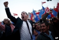 Supporters of Turkey's Justice and Development Party (AKP) celebrate as their leader and Turkish Prime Minister Ahmet Davutoglu arrives to deliver a speech during a rally, in Istanbul, Turkey, Oct. 7, 2015.