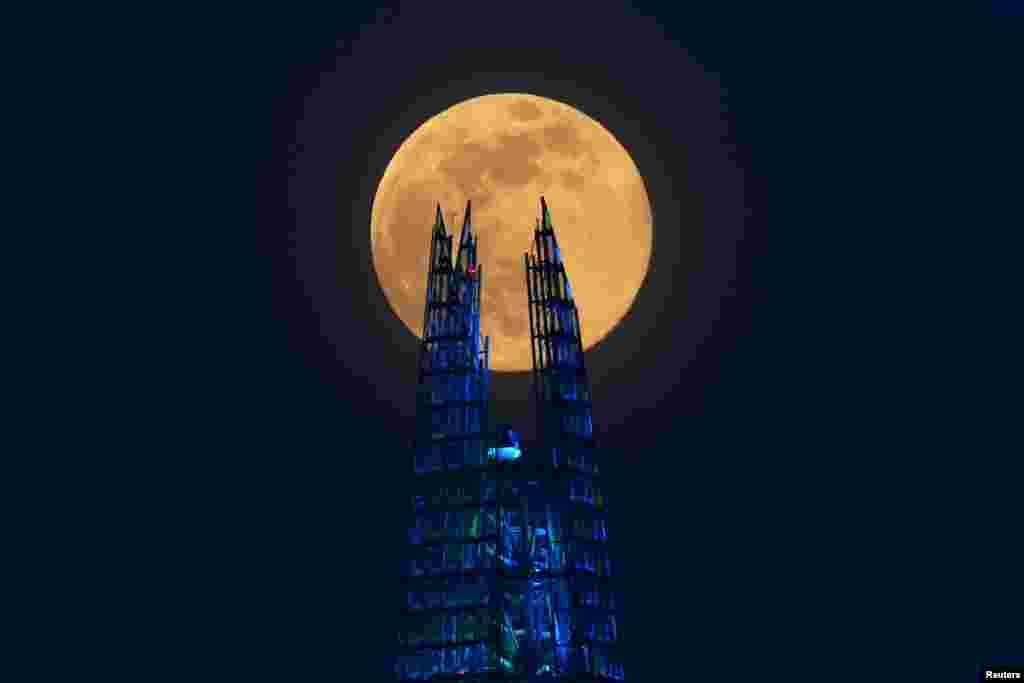 The Pink Supermoon rises over the Shard skyscraper in London in an astronomical event that occurs when the Moon is closest to the Earth in its orbit, making it appear much larger and brighter than usual, April 7, 2020.