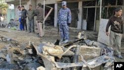 Iraqi security forces inspect the site of the bomb attack in Baghdad's Shaab District - the latest in a series of explosions that rocked Baghdad this day - in northern Baghdad, Iraq, December 22, 2011.