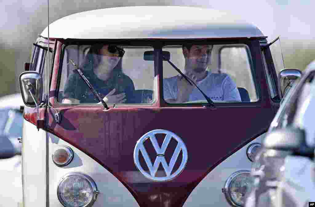 Believers pray in a old Volkswagen bus during a Good Friday church service at a drive-in cinema when all German churches are closed for worship due to the coronavirus outbreak in Duesseldorf, Germany.