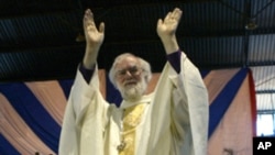 Anglican spiritual leader Archbishop Rowan Williams of Canterbury greets the congregants gathered at the City Sports Center in Harare on October 9, 2011.