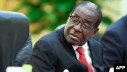FILE: Zimbabwe's President Robert Mugabe takes part in meetings with Chinese Premier Li Keqiang (not pictured) at the Great Hall of the People (GHOP) in Beijing, Aug. 26, 2014. 