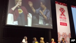 Graca Machel, right, wife of former president Nelson Mandela makes a point about the rights of young adolescent women as actress Charlize Theron looks on at the 2016 AIDS Conference in Durban, South Africa, July 19, 2016. 