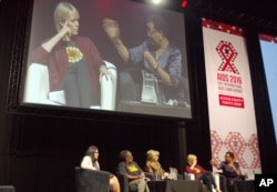 Graca Machel, right, wife of former president Nelson Mandela makes a point about the rights of young adolescent women as actress Charlize Theron looks on at the 2016 AIDS Conference in Durban, South Africa, July 19, 2016.