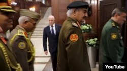 Yevgeny Prigozhin, background center, is seen at a meeting between Russian and Libyan military officials in Moscow, in a screengrab from footage published Nov. 7, 2018, by the self-styled Libyan National Army. 