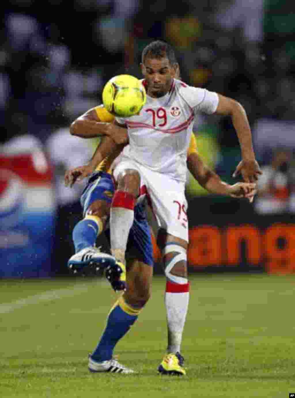 Tunisia's Sabeur Khalifa (front) challenges Lloyd Palun of Gabon during their African Cup of Nations Group C soccer match at Franceville stadium in Gabon January 31, 2012.
