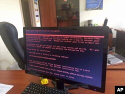 FILE - A computer screen cyberattack warning notice reportedly holding computer files to ransom, as part of a massive international cyberattack, at an office in Kyiv, Ukraine, June 27, 2017.