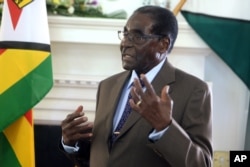 FILE - Zimbabwean President Robert Mugabe addresses his staff during a surprise birthday celebration event at State House in Harare, Feb. 22, 2016.