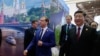 资料照片: 2018年11月5日时任俄罗斯总理梅德韦杰夫和中国国家主席习近平在上海参加首届中国国际进口博览会