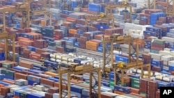Containers are seen in a port in Singapore. Singapore expects its economy to soar 15 percent this year after a record expansion in the second quarter that suggests Asia's recovery from the global recession remains on track (File)
