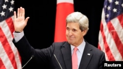 U.S. Secretary of State John Kerry waves after his lecture to students at Tokyo Institute of Technology in Tokyo April 15, 2013.