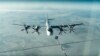 FILE - A Tu-95 strategic Russian bomber is in flight over Syria, from footage taken from the Russian Defense Ministry official website, Nov. 17, 2016. 