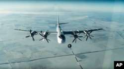 FILE - A Tu-95 strategic Russian bomber is in flight over Syria, from footage taken from Russian Defense Ministry official website, Nov. 17, 2016.
