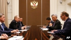 Russian President Vladimir Putin (2-L) meets with the President of the Asian Infrastructure Investment Bank (AIIB) Jin Liqun (2-R) in the Bocharov Ruchei residence in Sochi, Russia, May 18, 2016.