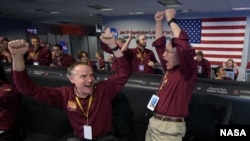 FILE - Mars InSight team react after receiving confirmation that the Mars InSight lander successfully touched down on the surface of Mars, Monday, Nov. 26, 2018 inside the Mission Support Area at NASA's Jet Propulsion Laboratory in Pasadena, California.