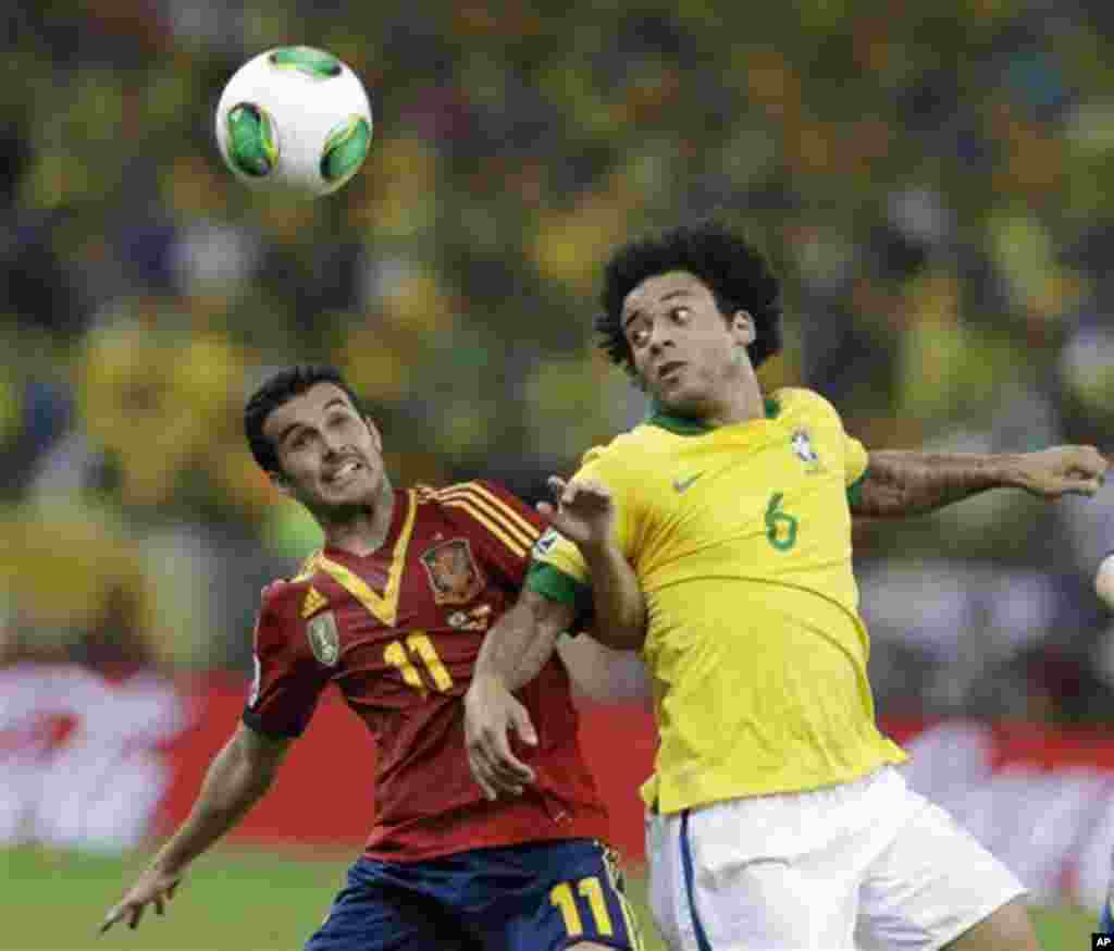 Spain's Pedro Rodriguez, left, and Brazil's Marcelo fight for the ball during the soccer Confederations Cup final match at the Maracana stadium in Rio de Janeiro, Brazil, Sunday, June 30, 2013. (AP Photo/Natacha Pisarenko)
