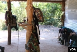 Camouflage uniforms and accessories hang inside the makeshift base camp in Tram Sasar commune of Srey Snam district on Dec. 21, 2017 (Sun Narin/VOA Khmer)